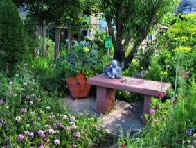 Add a bench so passersby can enjoy your garden habitat, too.